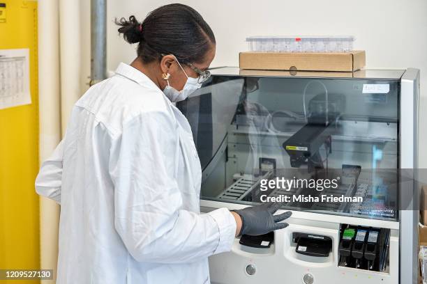 Fabiola Lewis, Immunohistochemistry technician, setting up equipment to test COVID-19 samples from recovered patients at Histowiz lab on April 8,...