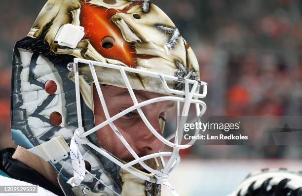 Aaron Dell of the San Jose Sharks looks on during a timeout against the Philadelphia Flyers on February 25, 2020 at the Wells Fargo Center in...