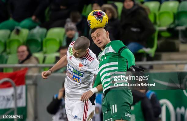 Janos Ferenczi of DVSC battles for the ball in the air with Oleksandr Zubkov of Ferencvarosi TC during the Hungarian OTP Bank Liga match between...