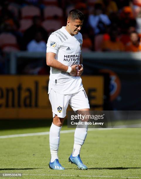 Javier Hernandez of Los Angeles Galaxy winces in pain as he takes a hard tackle against the Houston Dynamo during the first half at BBVA Stadium on...