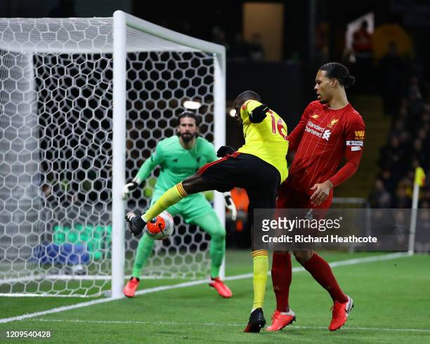 Abdoulaye Doucoure of Watford cuts the ball back around Virgil van Dijk of Liverpool for Sarr to score the first goal during the Premier League match...
