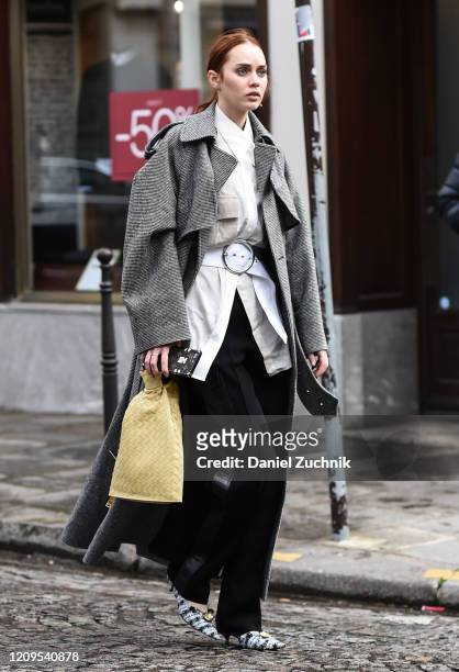 Tiernan Cowling is seen wearing a gray coat, white top, black pants and yellow bag outside the Altuzarra show during Paris Fashion Week: AW20 on...