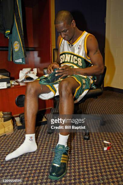 Ronald Murray of the Seattle Supersonics gets his sneakers ready in the locker room during the Rookie Challenge Presented by Got Milk as part of 2004...
