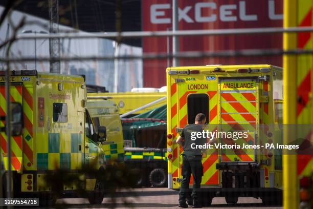 An NHS worker cleans down an ambulance outside the NHS Nightingale Hospital at the ExCel centre in London, a temporary hospital with 4000 beds which...