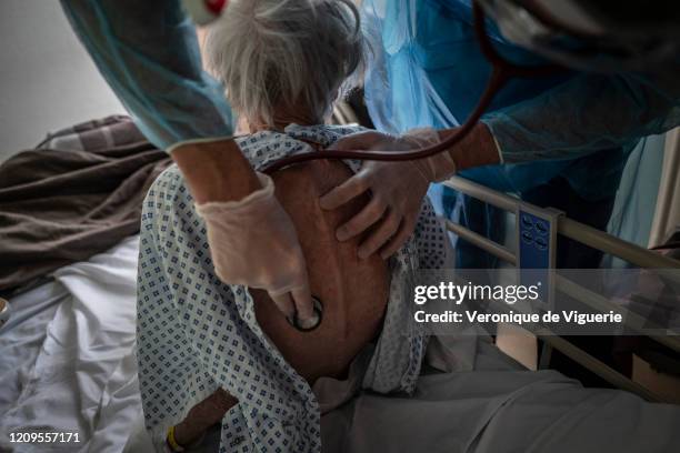 Doctor examines a coronavirus patient recovering at the Saint-Jean rehabilitation clinic on April 3, 2020 in Sentheim, France. By the beginning of...