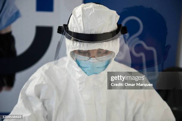 Health worker wears a protective mask and suit as she performs an antibody test for COVID-19 at the Dworska Hospital on April 9, 2020 in Krakow,...