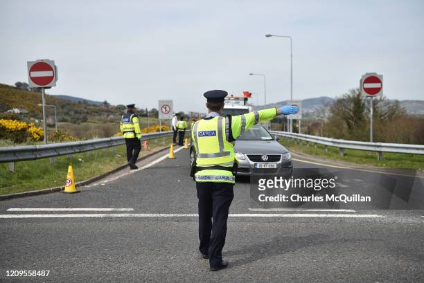 Gardai police officer mans a checkpoint on the border between the Republic of Ireland and Northern Ireland as they check for non essential travel...