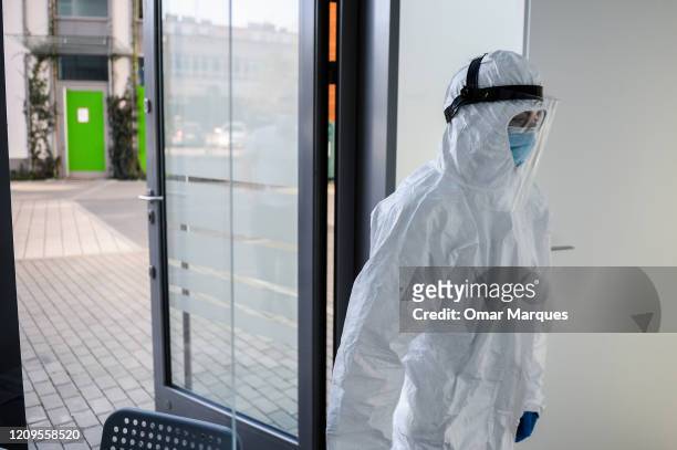 Health worker wears a protective mask and suit as she waits for a patient to perform an antibody test for COVID-19 at the Dworska Hospital on April...