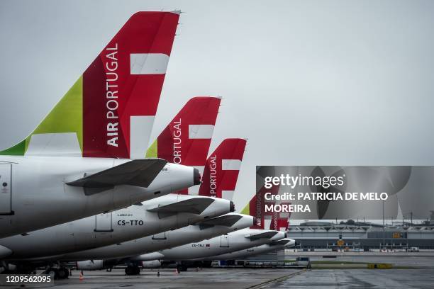 Airline aircrafts remain on the tarmac of the Humberto Delgado airport in Lisbon on April 9, 2020. - Portuguese government decided to suspend all...