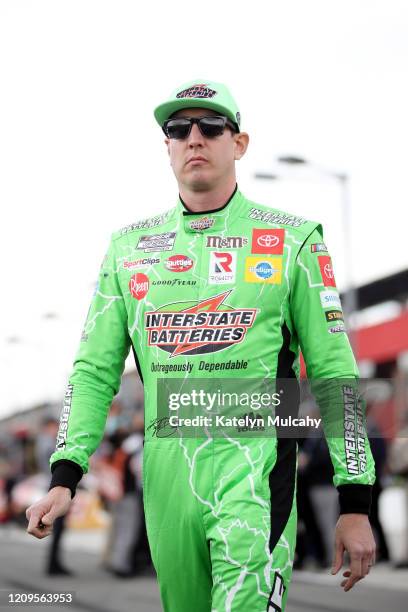 Kyle Busch, driver of the Interstate Batteries Toyota, walks on the grid before qualifying for the NASCAR Cup Series Auto Club 400 at Auto Club...