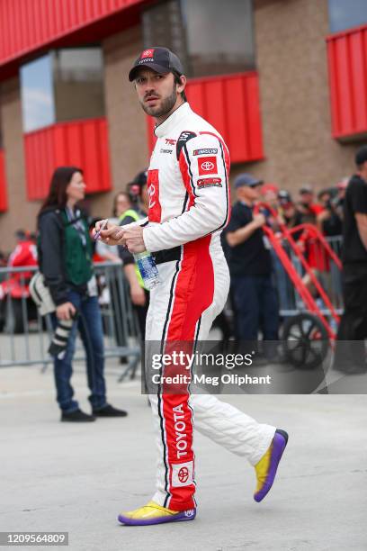 Daniel Suarez, driver of the Toyota Certified Used Vehicles Toyota, walks on the grid before qualifying at Auto Club Speedway on February 29, 2020 in...