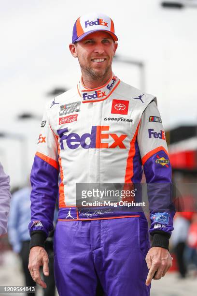 Denny Hamlin, driver of the FedEx Office Toyota, walks on the grid before qualifying at Auto Club Speedway on February 29, 2020 in Fontana,...