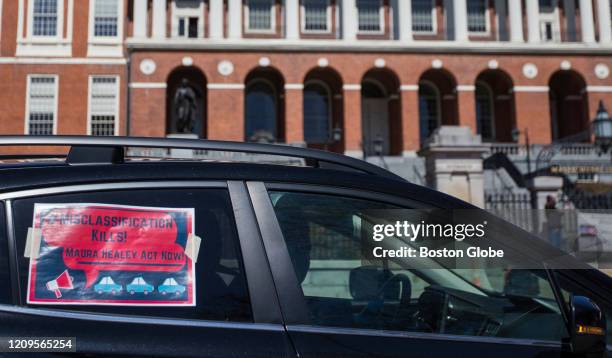 Uber and Lyft drivers participate in a "rolling rally" around the Boston Common on April 6 to protest the classification of ride share drivers as...