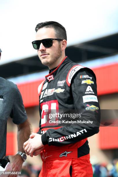 Alex Bowman, driver of the Cincinnati Chevrolet, walks on the grid before qualifying for the NASCAR Cup Series Auto Club 400 at Auto Club Speedway on...