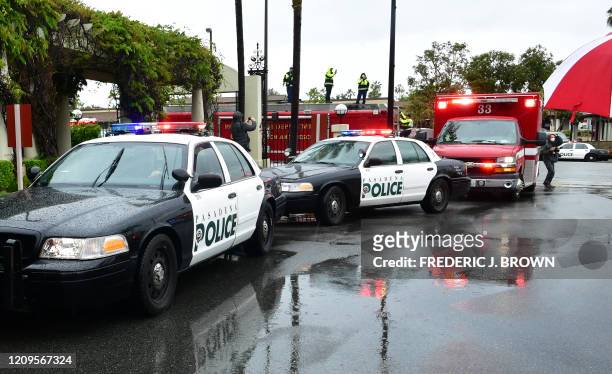 Pasadena police and fire department personnel flash emergency lights and blast their sirens in front of Huntington Hospital in Pasadena, California...