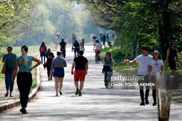 People exercise in Alexandra Park in north London on April 10, 2020 as warm weather tests the nationwide lockdown and the long Easter weekend begins....