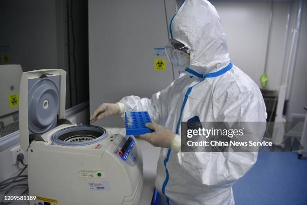 Researcher works on samples from people to be tested for the new coronavirus at a laboratory of Sichuan International Travel Healthcare Center on...