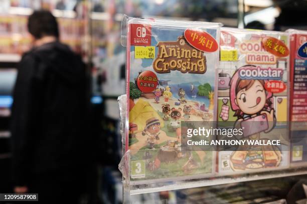 Copy of Nintendo computer game Animal Crossing: New Horizons is displayed in a shopping mall as a customer browses other games in Hong Kong on April...