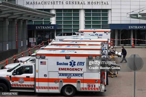 Boston EMS ambulance crew wheels in a patient to MGH from their ambulance in Boston on April 8, 2020. Hospitals brace for a surge in patients.