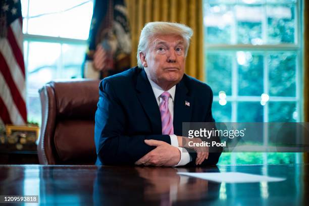 President Donald Trump pauses following speaking during a Easter blessing in the Oval Office of the White House on April 10, 2020 in Washington,...