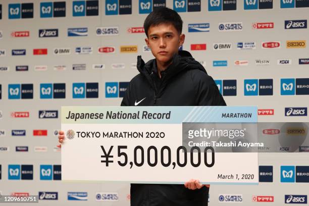 Men’s competition fourth place and new Japanese national record holder Suguru Osako of Japan poses for photograph during the awards ceremony...