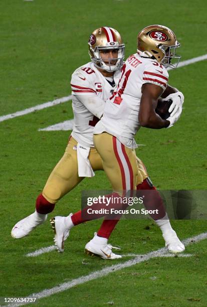 Raheem Mostert of the San Francisco 49ers takes the handoff from quarterback Jimmy Garoppolo against the Kansas City Chiefs in Super Bowl LIV at Hard...