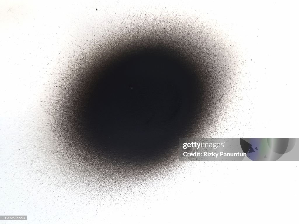 Close-up Of A Black Spray Paint Spot Isolated On White Background