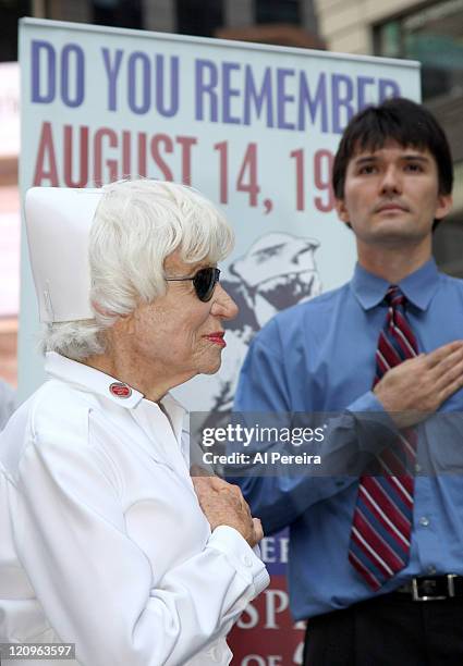 Nurse Edith Shain says a pledge of allegiance before she and Lt. Bob Skibar stage a reenactment of Alfred Eisenstaedt's famous Kiss Photo from August...