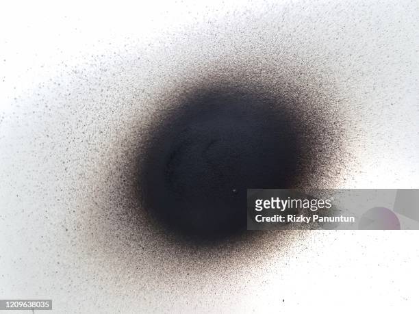 close-up of a black spray paint spot isolated on white background - spray paint isolated stock pictures, royalty-free photos & images