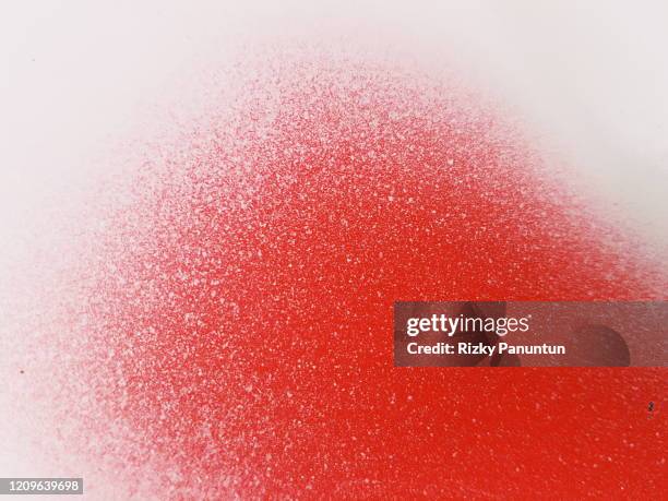 full frame of grey spray paint on red background - faded paper stock pictures, royalty-free photos & images