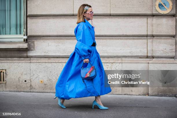 Carolina Ogliaro is seen wearing blue coat and belt Balenciaga, sunglasses with chain Sabine Be eyewear, Mulberry bag, Reikenen shoes during Paris...