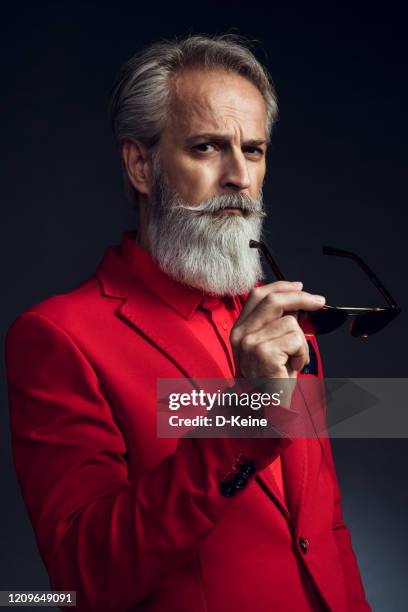 happy well dressed gentleman having photoshooting in studio - red suit stock pictures, royalty-free photos & images