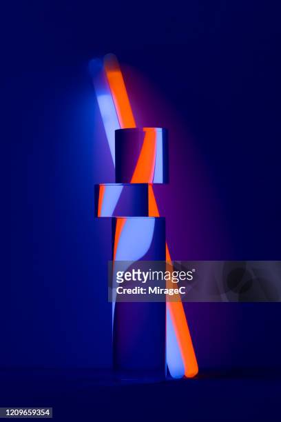 distorted refraction of illuminated glow sticks - kreuzmuster stock-fotos und bilder
