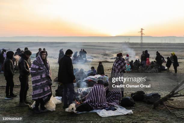 Refugees and migrants rest near Pazarkule border as they attempt to enter Greece from Turkey on March 01, 2020 in Edirne, Turkey. Turkey announced...