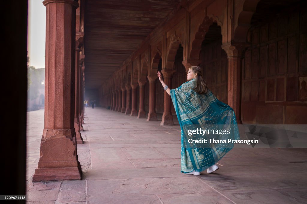 Smiling Woman In Sari Walking On Footpath