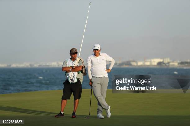 Sami Valimaki of Finland and caddie Kyle Roadley, look on in the first play off hole against Brandon Stone of South Africa during the final round of...