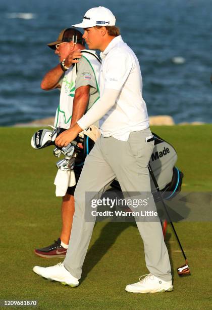 Sami Valimaki of Finland and caddie Kyle Roadley walk down the 18th hole in the third play off hole against Brandon Stone of South Africa during the...