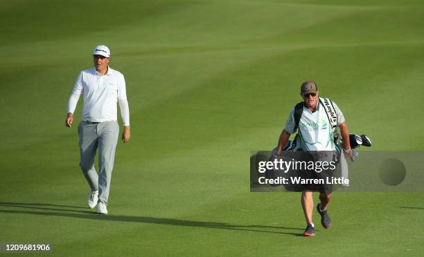 Sami Valimaki of Finland and caddie Kyle Roadley walk down the 18th hole in the second play off hole against Brandon Stone of South Africa during the...