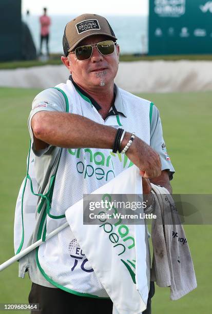 Kyle Roadley, caddie to the victorious Sami Valimaki of Finland removes the 18th green flag pin to keep as winning caddie during the final round of...