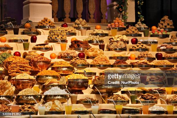 Mountains of sweets and vegetarian snacks are displayed in front of the deities at the BAPS Shri Swaminarayan Temple during the Annakut Darshan which...