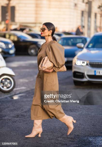 Victoria Barbara is seen wearing camel Givenchy dress, Bottega Veneta cork pouch bag Bottega boots, Givenchy sunglasses, Balenciaga earrings during...