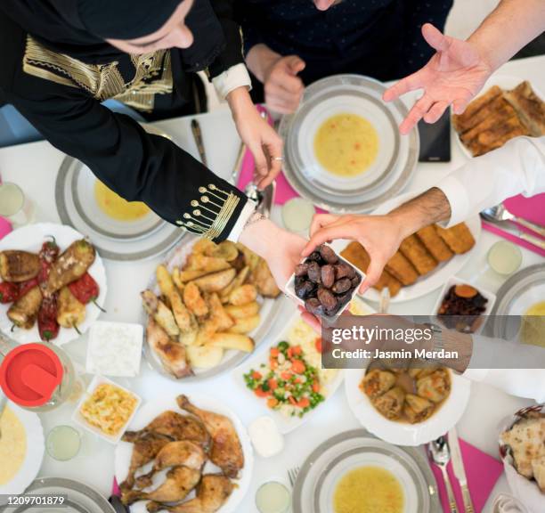 friends gathering for eating dinner together - arabic food stock-fotos und bilder