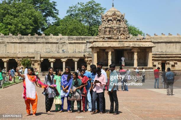 Group of Indian tourists take a selfie at the Brihadeeswarar Temple is a Hindu temple dedicated to Lord Shiva located in Thanjavur, Tamil Nadu,...