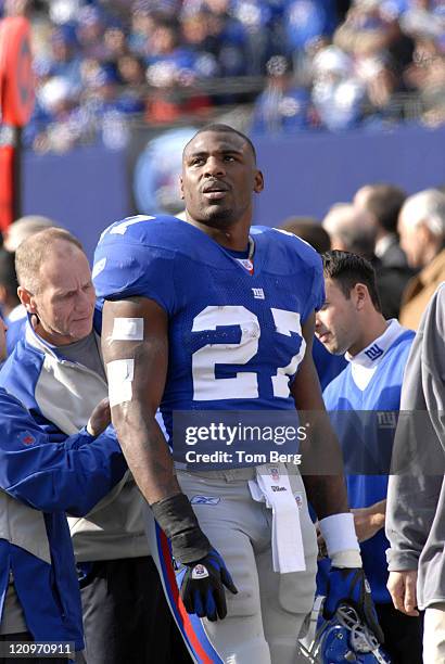 New York Giants running back Brandon Jacobs being worked on by New York Giants equipment manager Ed Wagner Jr. During the Houston Texans vs New York...