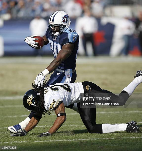 Tennessee Titans running back Travis Henry is tackled by Jacksonville Jaguars cornerback Rashean Mathis. The Tennessee Titans defeated the...