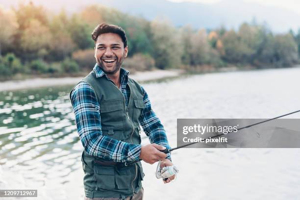 fisherman enjoying his hobby - fishing industry stock pictures, royalty-free photos & images