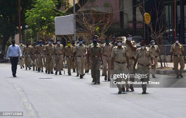 Dadar police station hold flag march appealing people to stay home, during nationwide lockdown due to COVID 19 pandemic at Worli, on April 11, 2020...