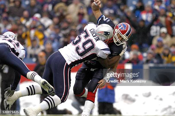 New England Patriots linebacker Rosevelt Colvin makes a hit on Buffalo Bills quarterback JP Losman after a pass in a game at Ralph Wilson Stadium in...