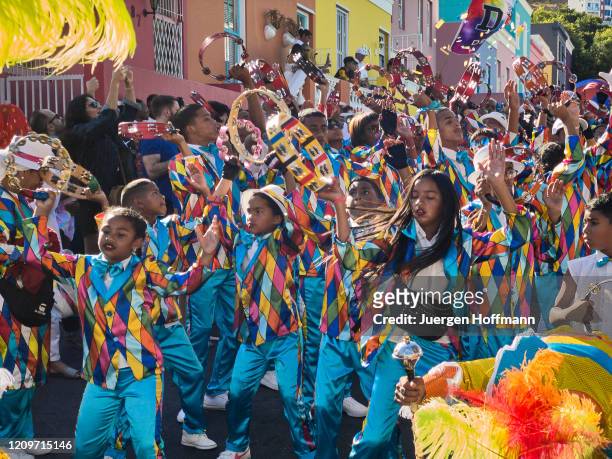 kids dancing and smiling while celebrating at kaapse klopse carnival in cape town on a sunny day - cape town bo kaap stock pictures, royalty-free photos & images