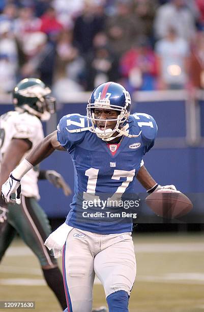 The New York Giants Wide Receiver Plaxico Burress celebrates after 61-yard reception and touchdown in the fourth quarter during Philadelphia Eagles...